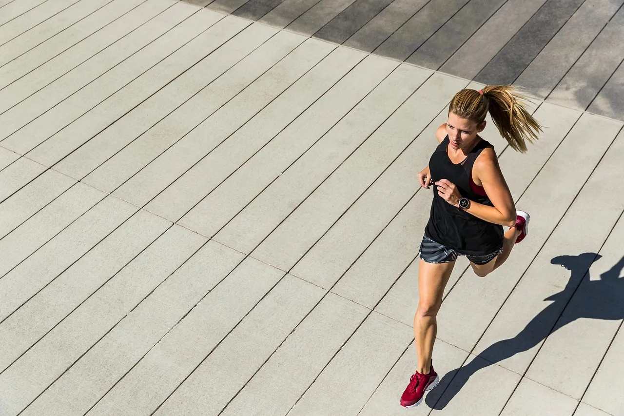 A woman running outdoors, evoking the exercise and lactate-clearance claims often used to market active recovery