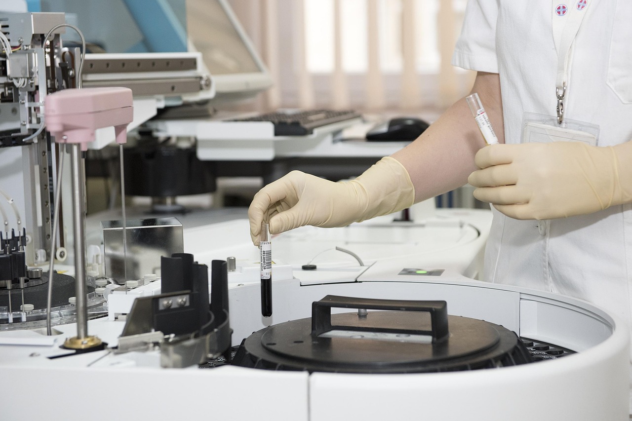 Scientist examining biological samples through a microscope in a research lab