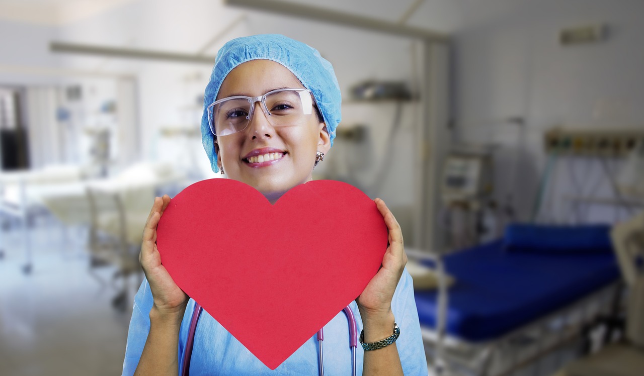 A nurse listening to a patient’s heart with a stethoscope during a cardiovascular checkup