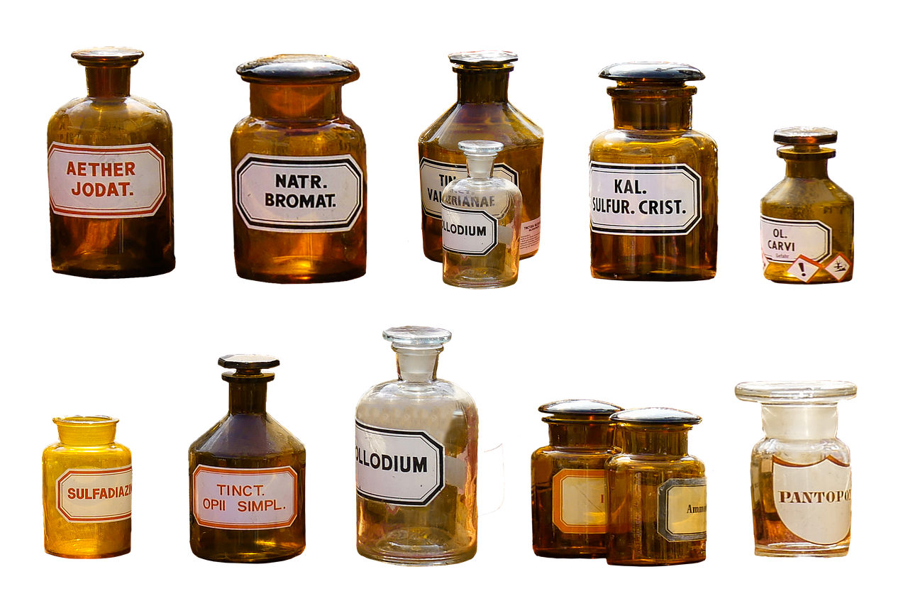 Glass vials and bottles of pharmaceutical liquid lined up in a lab