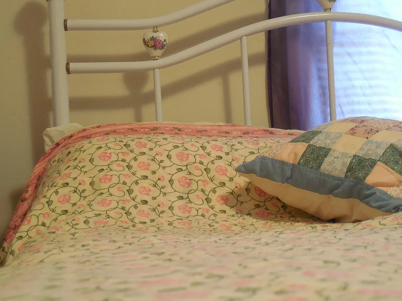 A neatly made bed with white pillows and linens, evoking the uninterrupted rest that good caffeine timing protects