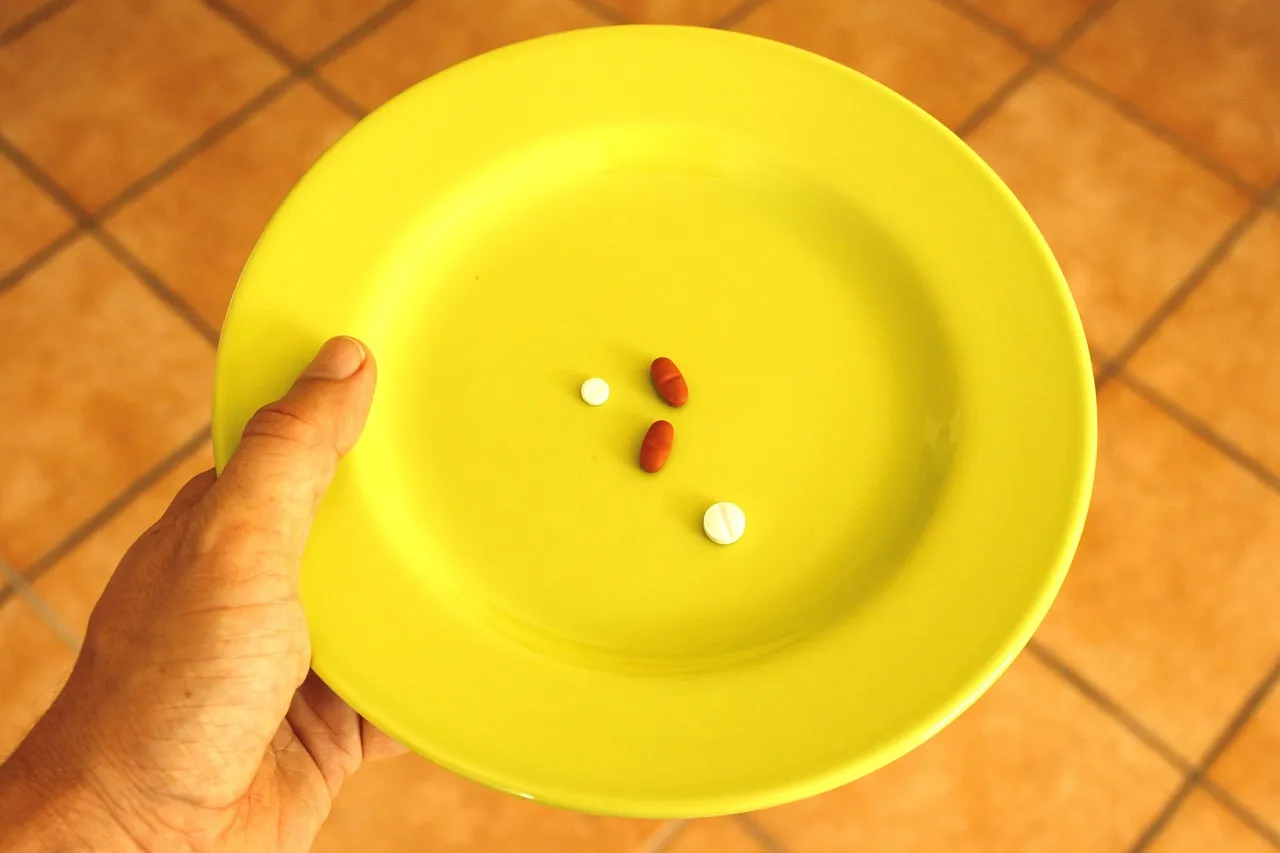 Pill, plate, pills — illustrating Cagrilintide: The Amylin Analog, Explained