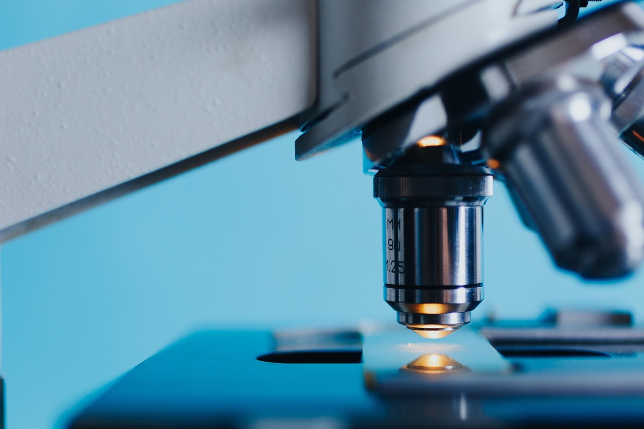 Scientist examining a sample under a laboratory microscope, representing the research behind growth-hormone secretagogues