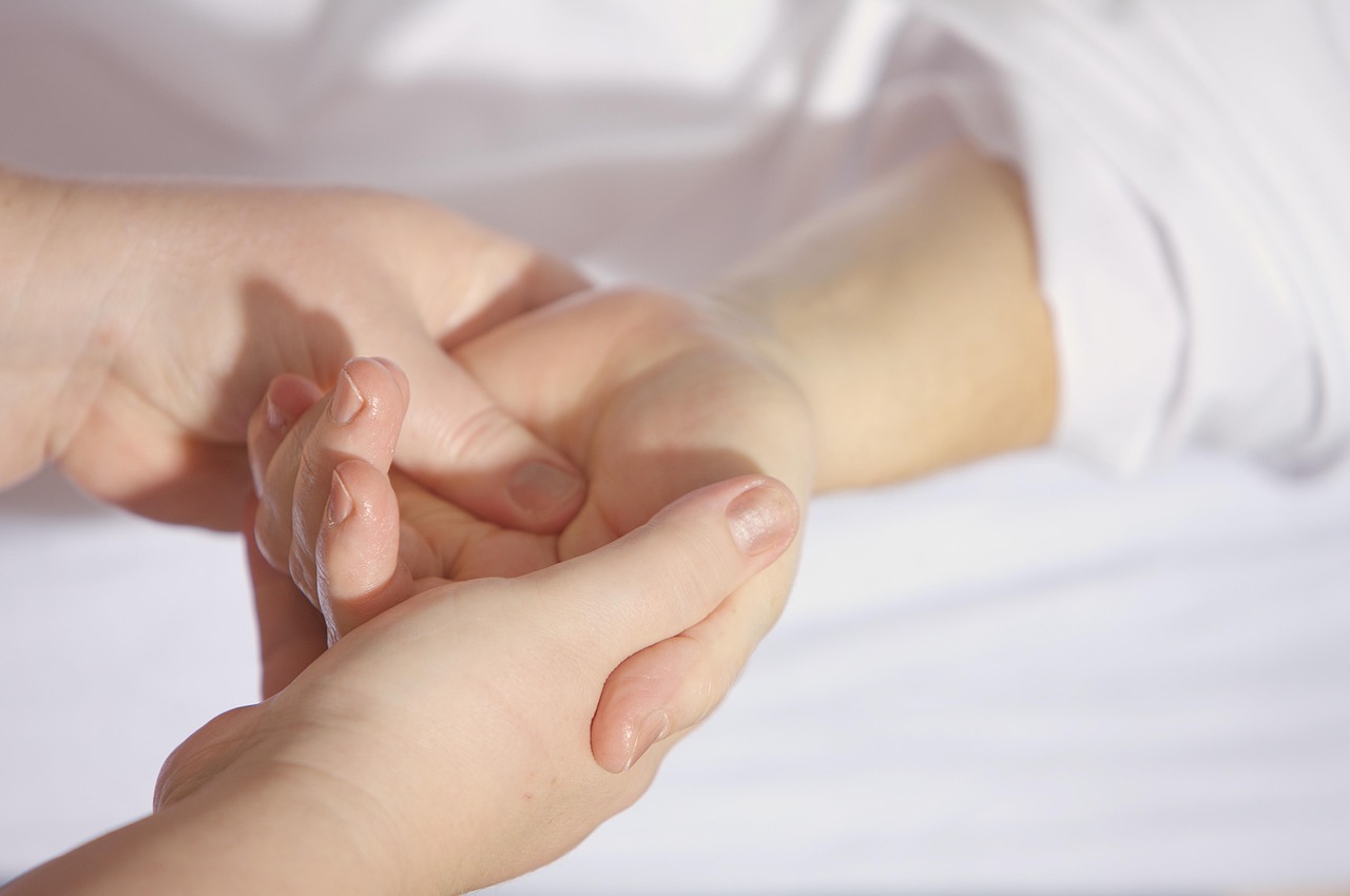 Close-up of a hand massage during a physiotherapy session, illustrating gentle recovery care rather than aggressive soreness treatment