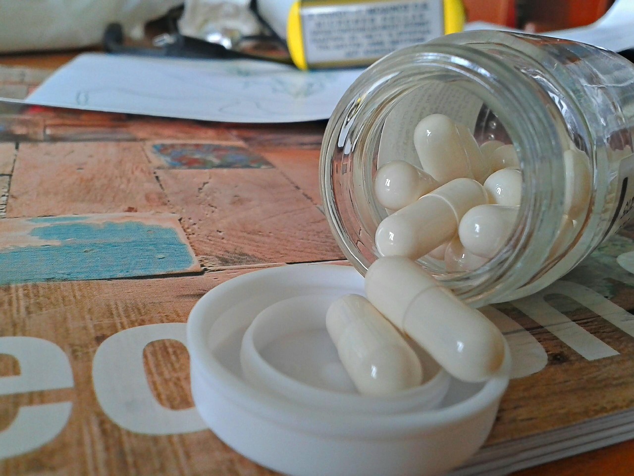 Pills, pill bottle, bottle — illustrating Peptide Dosing Units Explained: mcg, mg, mL, IU, and Insulin Units