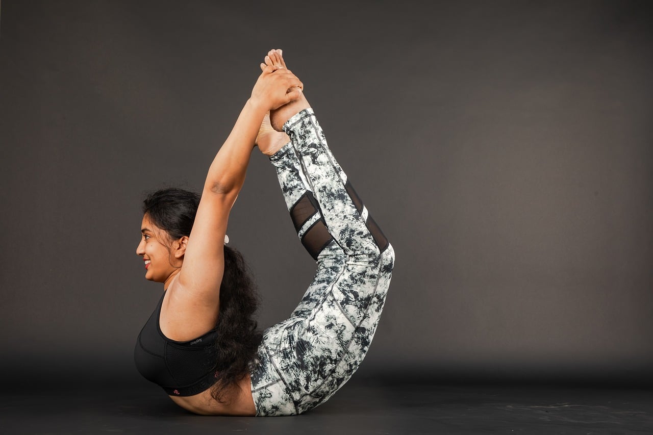 Woman, yoga, indoor yoga — illustrating Tart Cherry Juice and Recovery: A Look at the Data