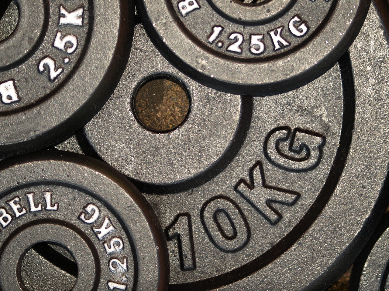 Weight plates, power, weight training — illustrating What Is Ozempic? A Plain-Language Explainer